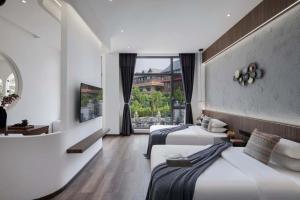 Postel nebo postele na pokoji v ubytování Xishuangbanna Verdant House Resort Hotel + 37 fotografií