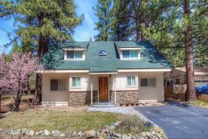a white house with a green roof at Corner Pocket Chalet home in South Lake Tahoe