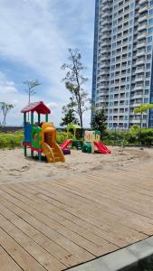 a playground with three play equipment in the sand at Apartemen Podomoro Deli Medan 42 m2 dengan 2 bed king size muat 4 orang dewasa in Medan +7 photos