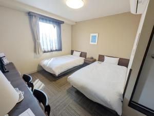 Postel nebo postele na pokoji v ubytování Hotel Route-Inn Court Shinonoi