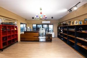 a room with a store with shelves and a chandelier at Orange Lodge in Bangkok