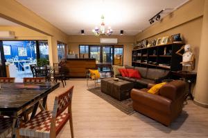 a living room with a couch and a table at Orange Lodge in Bangkok