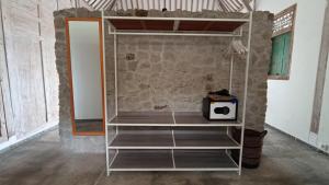 a empty shelf in a room with a stone wall at Sun Moon Star Villas with One Bedroom Private in Jarakan