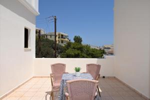 a patio with a table and chairs on a balcony at Maridim studios in Ermoupoli
