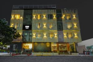 a building with lights on the side of it at Palette by CheckIn Goverdhan Villas Formerly The White Fresco in Udaipur