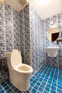 a blue bathroom with a toilet and a sink at Orange Lodge in Bangkok +75 photos