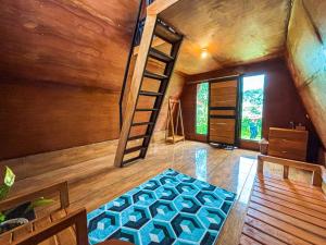 a room with a bunk bed and a ladder at Sanda Eco Cabins by AGATA in Padangan
