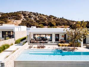 a villa with a swimming pool and a house at Hidden Hill Naxos Villas in Kastraki