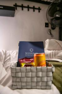 a basket with a book on top of a bed at Mandera's Boutique Suites & Dorms in Valletta