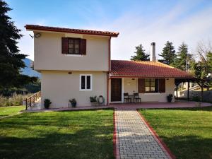 a white house with a red roof at Πολύμνια in Agia Anna