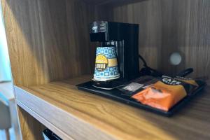a coffee maker sitting on top of a counter at Hyland Inn near Legoland in Carlsbad