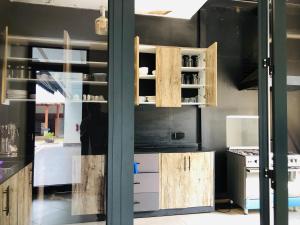 a kitchen with wooden cabinets and a window at AGASARO LUXURY Apartment in Kigali