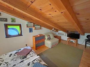 a bedroom with a bed and a tv in a room at Nives Garden house in Nerezine