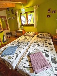 a bedroom with a bed with two towels on it at Nives Garden house in Nerezine