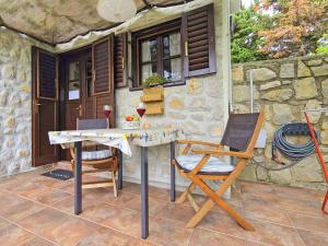 a table and two chairs on a patio at Nives Garden house in Nerezine
