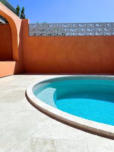 a swimming pool on a patio next to a house at Pacific Sun Bargara in Bargara