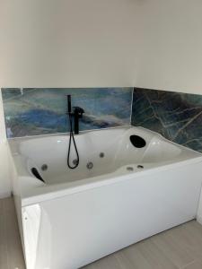 a white sink in a bathroom with a painting at RheinSchatz Apartments 3 in Oberwesel