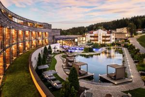 a rendering of a resort with a river and buildings at Wellness & Naturresort Reischlhof in Wegscheid