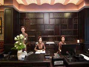 a group of three women standing in an office at Alagon D'antique Hotel & Spa in Ho Chi Minh City