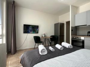 a bedroom with a bed with three pillows on it at New cozy studio, AC & Balcony in Bratislava