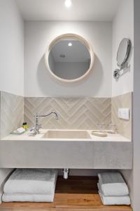 a bathroom with a sink and a mirror at Hôtel La Villa Sainte Valérie Adults Only in Juan-les-Pins