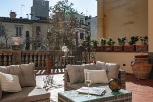 a patio with couches and a table on a balcony at La Casa di Liszt - Luxury Suites in Florence