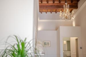a chandelier hanging from a ceiling in a room at La Casa di Liszt - Luxury Suites in Florence +15 photos