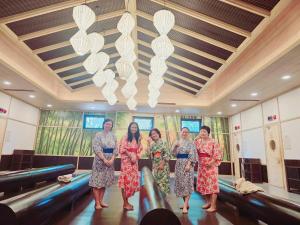 a group of women standing in a room at Khoáng nóng Wyndham Thanh Thủy Onsen in La Phu