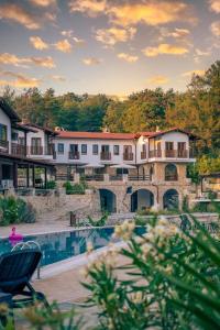 a view of a resort with a swimming pool at Rustic Modern Patio Home With Shared Pool in Kırıkyayla