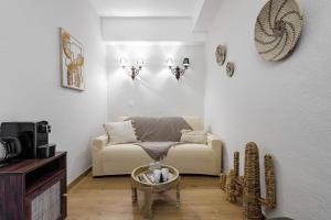 a living room with a couch and a coffee table at Hôtel La Villa Sainte Valérie Adults Only in Juan-les-Pins