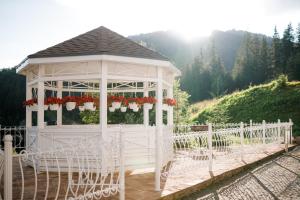 a white gazebo with flowers in it at Chevalier Hotel & SPA in Bukovel +120 photos