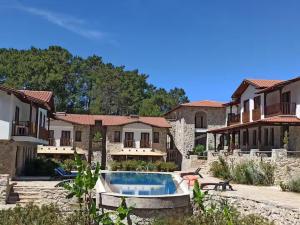 a house with a swimming pool in a yard at Rustic Modern Patio Home With Shared Pool in Kırıkyayla +12 photos