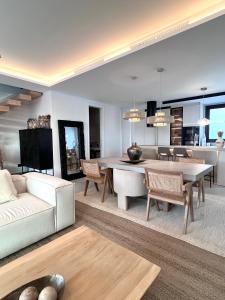 a living room with a white couch and a table at Casa Troia in Alhaurín de la Torre