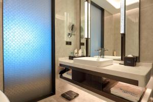 a bathroom with a sink and a mirror at Wyndham Shanwei Haifeng in Shanwei