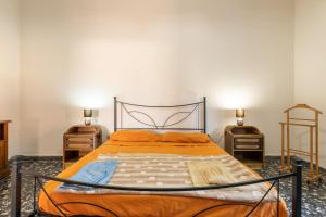 a bedroom with an orange bed with two night stands at Villetta Luisa in Villa San Pietro
