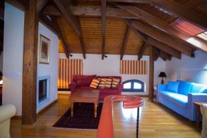 a living room with a couch and a chair at Maritsas Hotel & Suites in Portariá +64 photos