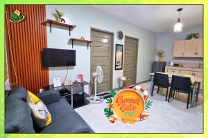 a living room with a blue couch and a kitchen at Central Comfort 2BR Furnished Stay in PPC - Richkizz in Puerto Princesa City