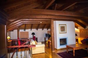 a living room with a couch and a fireplace at Maritsas Hotel & Suites in Portariá