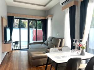 a living room with a couch and a table at Vina Villa At Krabi in Ao Nang 