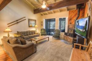 a living room with a couch and a tv at Eagle's Lake Retreat condo in Incline Village