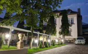 a car parked in front of a building at night at Hotel Boutique ANEMONA in Craiova