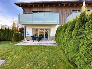 a house with a view of the backyard at Residenz Max mit eigenem Garten in Seefeld in Seefeld in Tirol