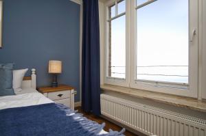 Postel nebo postele na pokoji v ubytování Ferienwohnung mit traumhaftem Meerblick - Haus am Meer FeWo 06