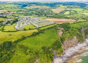an aerial view of a group of houses on a hill at Meadow House Holiday Park in Amroth