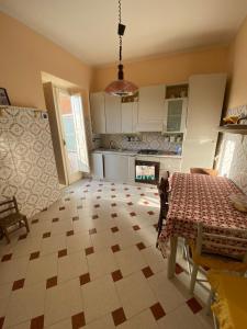 a kitchen with a table and a fireplace at Antica dimora Cauto in Pietramelara