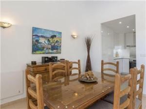 ein Esszimmer mit einem Holztisch und Stühlen in der Unterkunft La Manga Club Resort - Los Olivos 417 in Atamaría + 26 Fotos