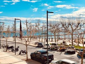 a parking lot with cars and a parking lot with trees at Global Immo 3390 Marítim 1A in Roses