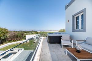 a patio with a couch and a table at Villa Irene Royale - Pool - Sea View - Free Cruise in Tigaki