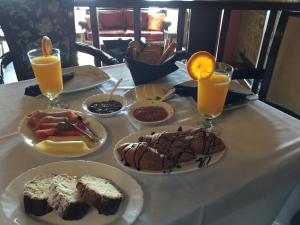 a table with plates of food and two glasses of orange juice at Varosi Guesthouse in Edessa