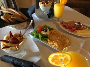 a table topped with plates of food and drinks at Varosi Guesthouse in Edessa
